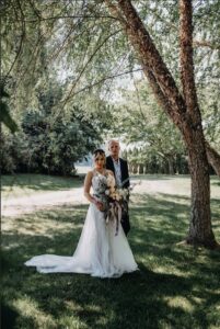 Bride and Groom pose in the property yard.