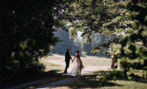 Bride and Groom walking through the yard.